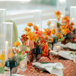 Orange table florals from Scout Floral in Dallas Texas.