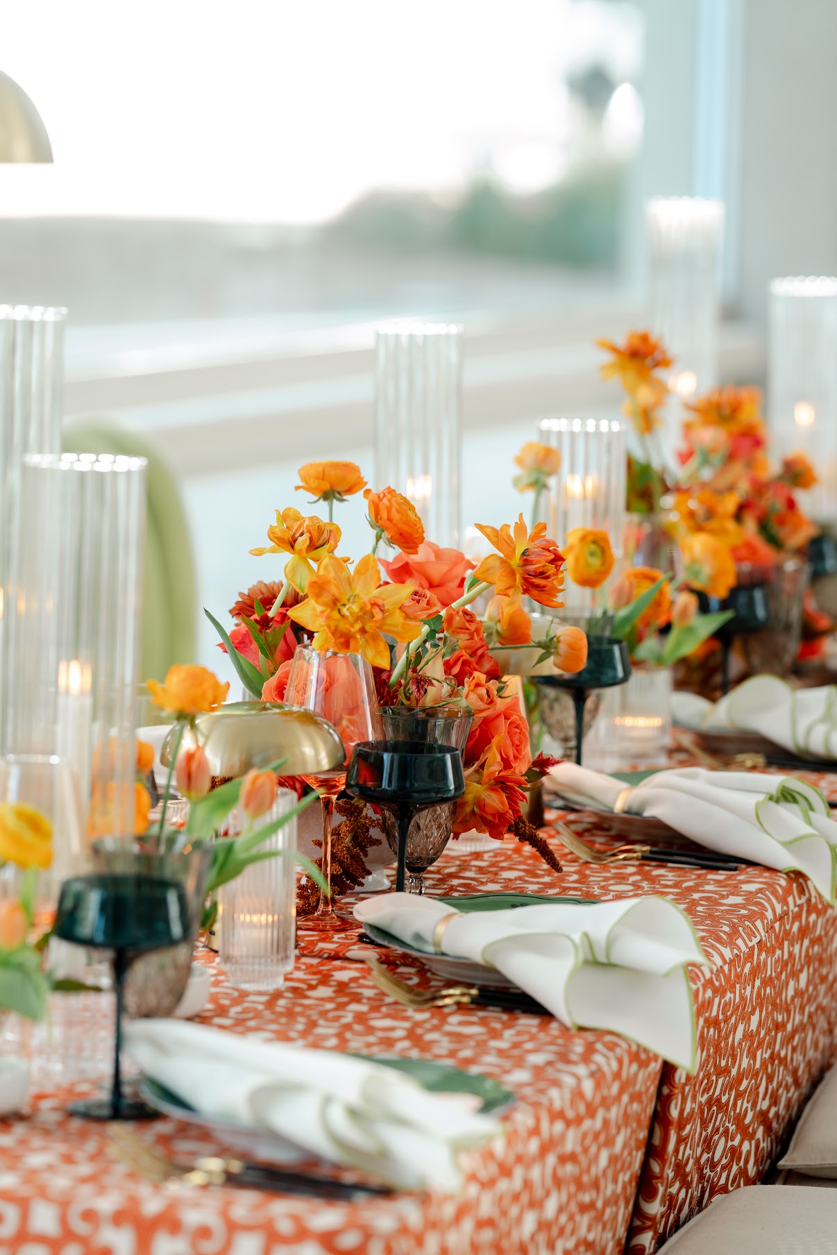 Orange table florals from Scout Floral in Dallas Texas.