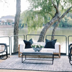 A custom lounge area for wedding guests to enjoy overlooking water.