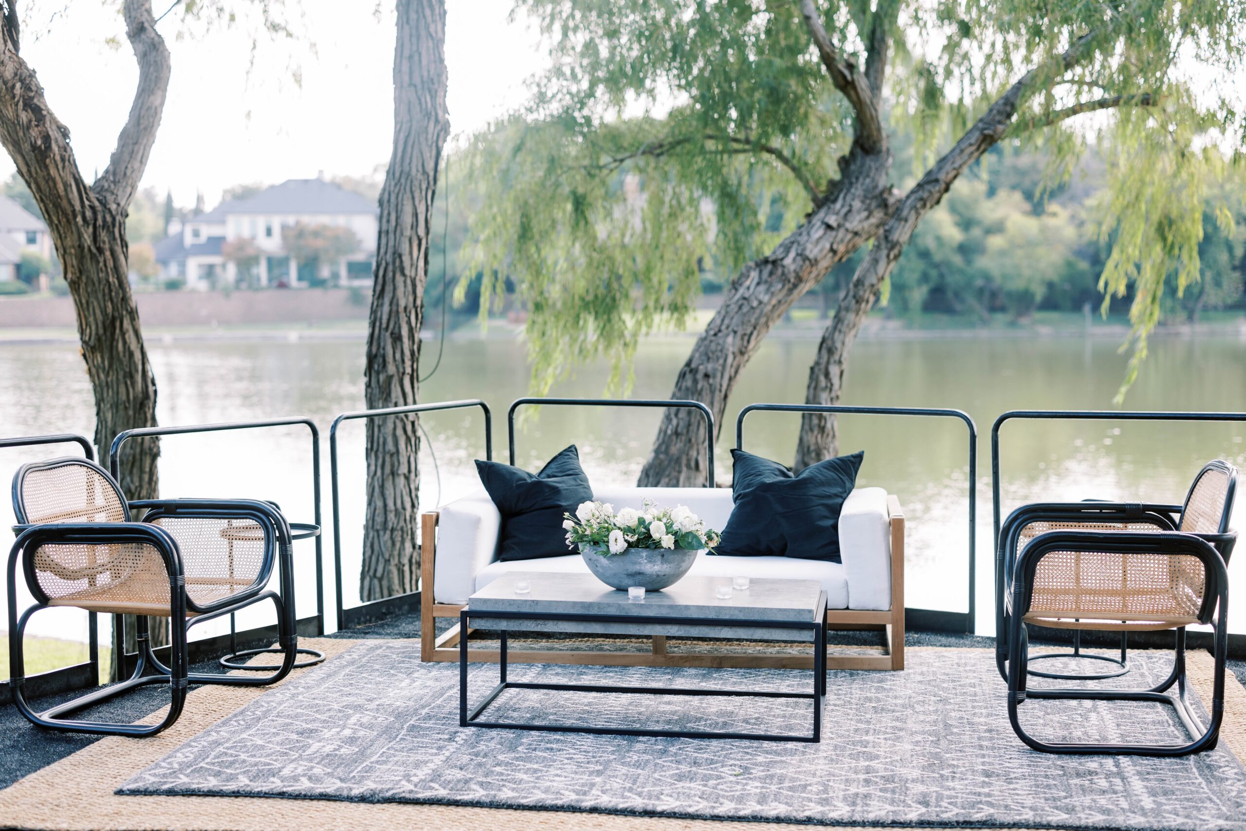 A custom lounge area for wedding guests to enjoy overlooking water.